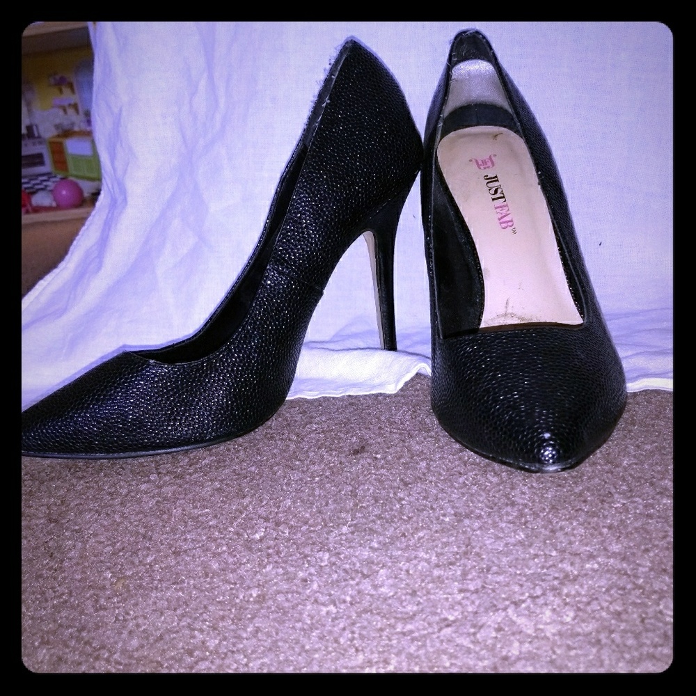 Black heels with a faux snake skin texture.